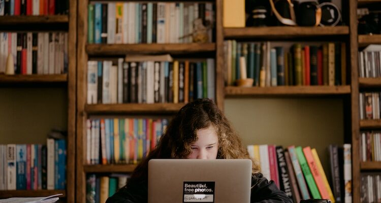 woman in black long sleeve shirt using macbook